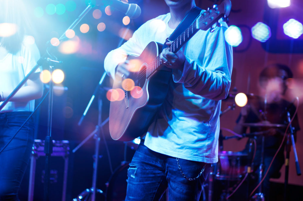 guitarist on a live music venue stage