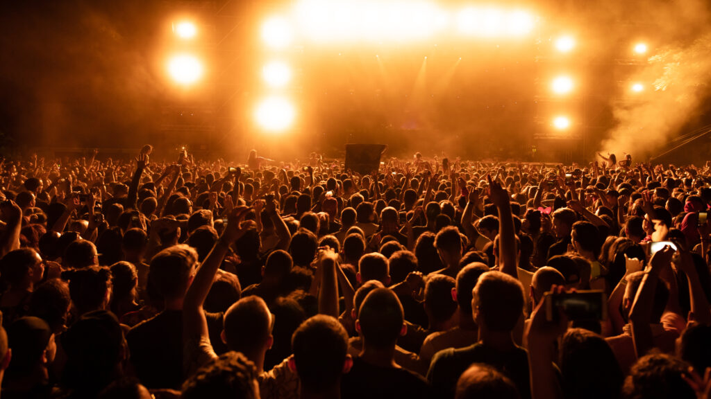 back view crowd fans watching live performance music concert night copy space 1024x576 1 - Prism.fm